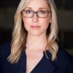 Headshot of Kathleen Belew. White woman, blond hair, & glasses