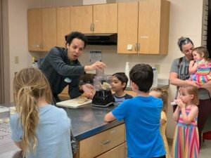 Adult demonstrating an activity for children.